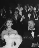 Sophia Loren and Paolo Stoppa. Silvana Mangano smoking in the background right. 27 April 1955. - Photo by Edward Quinn