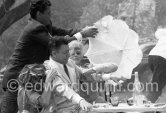 Paul Meurisse (white suit) during filming of “Le Déjeuner sur l'herbe” at the Auguste Renoir house "Les Collettes". With the aid of mechanical wind devices a tempest, the mistral, turns the déjeuner into catastrophe. Cagnes-sur-Mer 1959. - Photo by Edward Quinn