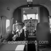 La Môme Moineau (the kid sparrow), "the richest woman of the Côte d'Azur", former flower seller married to husband Mr. Benítez-Rexach, Dominican ship building millionaire. Sitting in one of her husbands gifts, a Beech 18 (85’000’000 francs). Cannes Airport 1954. - Photo by Edward Quinn