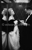 Kim Novak, with Rupert Allan of LOOK Magazine. In the lift of the Carlton Hotel, Cannes 1956. - Photo by Edward Quinn
