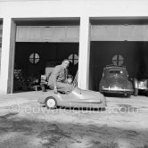 Aristotle and his son Alexander Onassis. Château de la Croë. Cap d'Antibes 1954. Car in garage: Renault 4CV - Photo by Edward Quinn