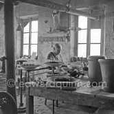 Pablo Picasso at work at the Madoura pottery in Vallauris. Above him is a statue of St-Claude, the patron saint of the potters, whose name was given to his younger son. Vallauris 23.3.1953. - Photo by Edward Quinn