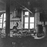 Pablo Picasso at work at the Madoura pottery in Vallauris. Above him is a statue of St-Claude, the patron saint of the potters, whose name was given to Pablo Picasso's younger son. Vallauris 23.3.1953. - Photo by Edward Quinn