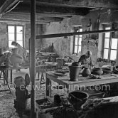 Pablo Picasso and Suzanne Ramié (in the background) at work at the Madoura pottery in Vallauris. Above him is a statue of St-Claude, the patron saint of the potters, whose name was given to his younger son. Vallauris 23.3.1953. - Photo by Edward Quinn