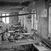 Pablo Picasso and Suzanne Ramié (in the background) at work at the Madoura pottery in Vallauris. Above him is a statue of St-Claude, the patron saint of the potters, whose name was given to his younger son. Vallauris 23.3.1953. - Photo by Edward Quinn