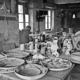 Pablo Picasso at work at the Madoura pottery in Vallauris. Above him is a statue of St-Claude, the patron saint of the potters, whose name was given to his younger son. Vallauris 23.3.1953. - Photo by Edward Quinn