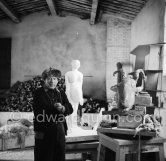 Pablo Picasso in his studio Le Fournas. In winter, Pablo Picasso wore warm clothes inside the studio, as heating was minimized to prevent the sculptures from drying too quickly., Vallauris 1953. - Photo by Edward Quinn