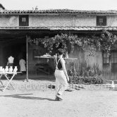 A potter carrying some figures Pablo Picasso made in clay to the kiln. Outside Madoura pottery. Vallauris 1953. - Photo by Edward Quinn