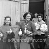 Madame Paule de Lazerme (she had an affair with Pablo Picasso for some months) and Rosa (Rosita) Hugué (left), adopted daughter of Jeanne Hugué ("Totote"), with Pablo Picasso ceramics in front of Le Fournas. Right: not yet identified man with chouette. Pablo Picasso in the background. Vallauris 1953. - Photo by Edward Quinn