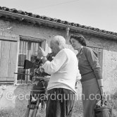 Pablo Picasso checking a camera angle (documentary film of Luciano Emmer). With Madame Paule de Lazerme (she had an affair with Pablo Picasso for some months) who wears a necklace designed by Pablo Picasso. In front of the studio Le Fournas, Vallauris 1953. - Photo by Edward Quinn