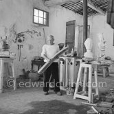 Pablo Picasso working in his sculpture studio Le Fournas making a sculpture figure with odds and ends from his scrap heap. The finished sculpture got the name "La femme à la clé (La Taulière)" ("Woman with a key"). Le Fournas, Vallauris 1953. - Photo by Edward Quinn