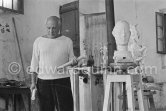 Pablo Picasso working in his sculpture studio Le Fournas making a sculpture figure with odds and ends from his scrap heap. The finished sculpture got the name "La femme à la clé (La Taulière)" ("Woman with a key"). Le Fournas, Vallauris 1953. - Photo by Edward Quinn