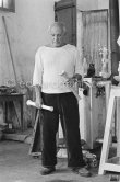 Pablo Picasso working in his sculpture studio Le Fournas making a sculpture figure with odds and ends from his scrap heap. The finished sculpture got the name "La femme à la clé (La Taulière)" ("Woman with a key"). Le Fournas, Vallauris 1953. - Photo by Edward Quinn
