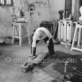 Pablo Picasso working in his sculpture studio Le Fournas making a sculpture figure with odds and ends from his scrap heap. The finished sculpture got the name "La femme à la clé (La Taulière)" ("Woman with a key"). Le Fournas, Vallauris 1953. - Photo by Edward Quinn