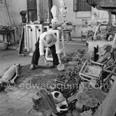 Pablo Picasso working in his sculpture studio Le Fournas making a sculpture figure with odds and ends from his scrap heap. The finished sculpture got the name "La femme à la clé (La Taulière)" ("Woman with a key"). Le Fournas, Vallauris 1953. - Photo by Edward Quinn