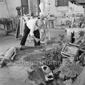 Pablo Picasso working in his sculpture studio Le Fournas making a sculpture figure with odds and ends from his scrap heap. The finished sculpture got the name "La femme à la clé (La Taulière)" ("Woman with a key"). Le Fournas, Vallauris 1953. - Photo by Edward Quinn