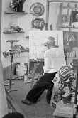 Pablo Picasso doing a charcoal drawing of the view from Le Fournas during filming of Luciano Emmer's documentary. Vallauris 26.6.1953. - Photo by Edward Quinn