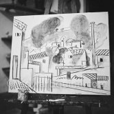Pablo Picasso doing a charcoal drawing of the view from Le Fournas during filming of Luciano Emmer's documentary. Vallauris 26.6.1953. - Photo by Edward Quinn