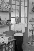 Pablo Picasso in front of a board with ceramics. Le Fournas, Vallauris 1953. - Photo by Edward Quinn