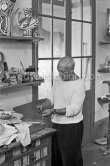 Pablo Picasso in front of a board with ceramics. Le Fournas, Vallauris 1953. - Photo by Edward Quinn