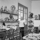 Pablo Picasso in front of a board with ceramics. Le Fournas, Vallauris 1953. - Photo by Edward Quinn
