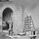 Picasso working on the "War and Peace study" drawings on the wall of "Chapelle de la Paix" (or "Temple de la Paix") for the documentary film of Luciano Emmer. (The panels of War and Peace of 1952 were away on exhibition). Vallauris 1953. - Photo by Edward Quinn