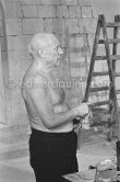 Pablo Picasso working on the "War and Peace study" drawings on the wall of Chapelle de la Paix (or Temple de la Paix) for the documentary film of Luciano Emmer. (The panels of War and Peace of 1952 were away on exhibition). Vallauris 1953. - Photo by Edward Quinn