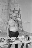 Pablo Picasso working on the "War and Peace study" drawings on the wall of Chapelle de la Paix (or Temple de la Paix) for the documentary film of Luciano Emmer. (The panels of War and Peace of 1952 were away on exhibition). Vallauris 1953. - Photo by Edward Quinn