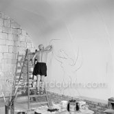 Pablo Picasso working on the "War and Peace study" drawings on the wall of Chapelle de la Paix (or Temple de la Paix) for the documentary film of Luciano Emmer. (The panels of War and Peace of 1952 were away on exhibition). Vallauris 1953. - Photo by Edward Quinn