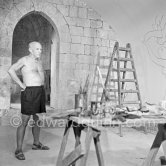 Pablo Picasso working on the "War and Peace study" drawings on the wall of Chapelle de la Paix (or Temple de la Paix) for the documentary film of Luciano Emmer. (The panels of War and Peace of 1952 were away on exhibition). Vallauris 1953. - Photo by Edward Quinn