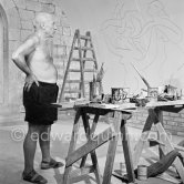 Pablo Picasso working on the "War and Peace study" drawings on the wall of Chapelle de la Paix (or Temple de la Paix) for the documentary film of Luciano Emmer. (The panels of War and Peace of 1952 were away on exhibition). Vallauris 1953. - Photo by Edward Quinn