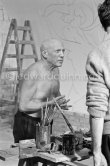 Pablo Picasso working on the "War and Peace study" drawings on the wall of Chapelle de la Paix (or Temple de la Paix) for the documentary film of Luciano Emmer. (The panels of War and Peace of 1952 were away on exhibition). Vallauris 1953. - Photo by Edward Quinn