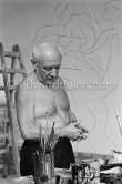 Pablo Picasso working on the "War and Peace study" drawings on the wall of Chapelle de la Paix (or Temple de la Paix) for the documentary film of Luciano Emmer. (The panels of War and Peace of 1952 were away on exhibition). Vallauris 1953. - Photo by Edward Quinn