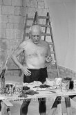 Picasso working on the "War and Peace study" drawings on the wall of Chapelle de la Paix (or Temple de la Paix) for the documentary film of Luciano Emmer. (The panels of War and Peace of 1952 were away on exhibition). Vallauris 1953. - Photo by Edward Quinn