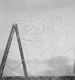 Pablo Picasso working on the "War and Peace study" drawings on the wall of Chapelle de la Paix (or Temple de la Paix) for the documentary film of Luciano Emmer. (The panels of War and Peace of 1952 were away on exhibition). Vallauris 1953. - Photo by Edward Quinn