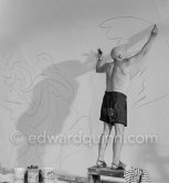 Pablo Picasso working on the "War and Peace study" drawings on the wall of Chapelle de la Paix (or Temple de la Paix) for the documentary film of Luciano Emmer. (The panels of War and Peace of 1952 were away on exhibition). Vallauris 1953. - Photo by Edward Quinn