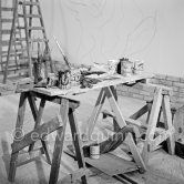 Pablo Picasso working on the "War and Peace study" drawings on the wall of Chapelle de la Paix (or Temple de la Paix) for the documentary film of Luciano Emmer. (The panels of War and Peace of 1952 were away on exhibition). Vallauris 1953. - Photo by Edward Quinn