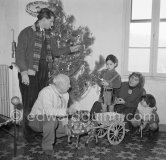 A rare document of Pablo Picasso with his four children, Paloma Picasso, Maya Picasso, Claude Picasso and Paulo Picasso. Christmastime at La Galloise. The wagon was a gift and comes from Sicily. Vallauris 1953. - Photo by Edward Quinn