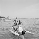 Xavier Vilató, left on pedalo, behind Picasso Paulo, Francisco Reina "El Minuni”, banderillero Andaluz. Golfe-Juan 1954. - Photo by Edward Quinn