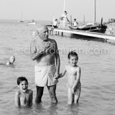 Claude, Paloma. at beach, in the water, Picasso swimming. Golfe-Juan 1954. - Photo by Edward Quinn