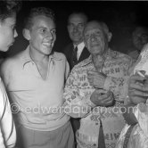 Pablo Picasso exchanges his shirt with a singer on the occasion of a concert at Golfe-Juan or Juan-les-Pins 1954. - Photo by Edward Quinn