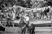 Françoise Gilot, led the toreadors into the bull ring and is here seen shaking hands with Pablo Picasso. On the grandstand singer Yolanda on Pablo Picasso's right, Hélène Parmelin, Edouard Pignon, far right Paloma Picasso with her nanny. Corrida Vallauris 1954. - Photo by Edward Quinn
