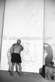 Pablo Picasso working on a bucolic pastoral scene on drawing paper which was to serve as background for the film "Le mystère Picasso". Nice, Studios de la Victorine 1955. - Photo by Edward Quinn