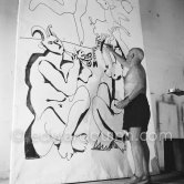 Pablo Picasso working on a bucolic pastoral scene on drawing paper which was to serve as background for the film "Le mystère Picasso". Nice, Studios de la Victorine 1955. - Photo by Edward Quinn