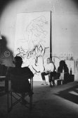 Pablo Picasso working on a bucolic pastoral scene on drawing paper which was to serve as background for the film "Le mystère Picasso". Maya Picasso on the right. Nice, Studios de la Victorine 1955. - Photo by Edward Quinn