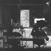 Pablo Picasso working on a bucolic pastoral scene on drawing paper which was to serve as background for the film "Le mystère Picasso". Nice, Studios de la Victorine 1955. - Photo by Edward Quinn
