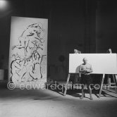 Pablo Picasso working on a bucolic pastoral scene on drawing paper which was to serve as background for the film "Le mystère Picasso". Nice, Studios de la Victorine 1955. - Photo by Edward Quinn