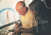 Pablo Picasso, watched by Maya Picasso, painting on a Bota de vino (bota bag or wineskin). "Le mystère Picasso", Nice, Studios de la Victorine 1955. - Photo by Edward Quinn