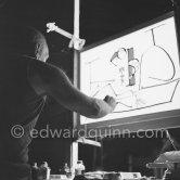During filming of "Le mystère Picasso". Pablo Picasso working on "Nature morte". Pablo Picasso had a frame constructed on which he could stretch a transluscent piece of paper. He drew on one side, and the camera filmed the drawing being born from the other side. Nice, Studios de la Victorine 1955. - Photo by Edward Quinn
