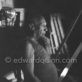 During filming of "Le mystère Picasso". Pablo Picasso working on "Nature morte". Pablo Picasso had a frame constructed on which he could stretch a transluscent piece of paper. He drew on one side, and the camera filmed the drawing being born from the other side. Nice, Studios de la Victorine 1955. - Photo by Edward Quinn